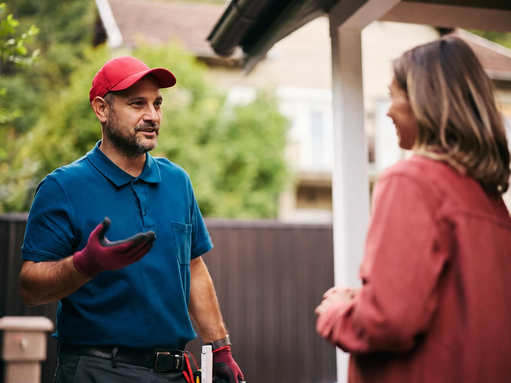 Rapid Plumbing technician discussing trenchless sewer repair with an Orange County homeowner