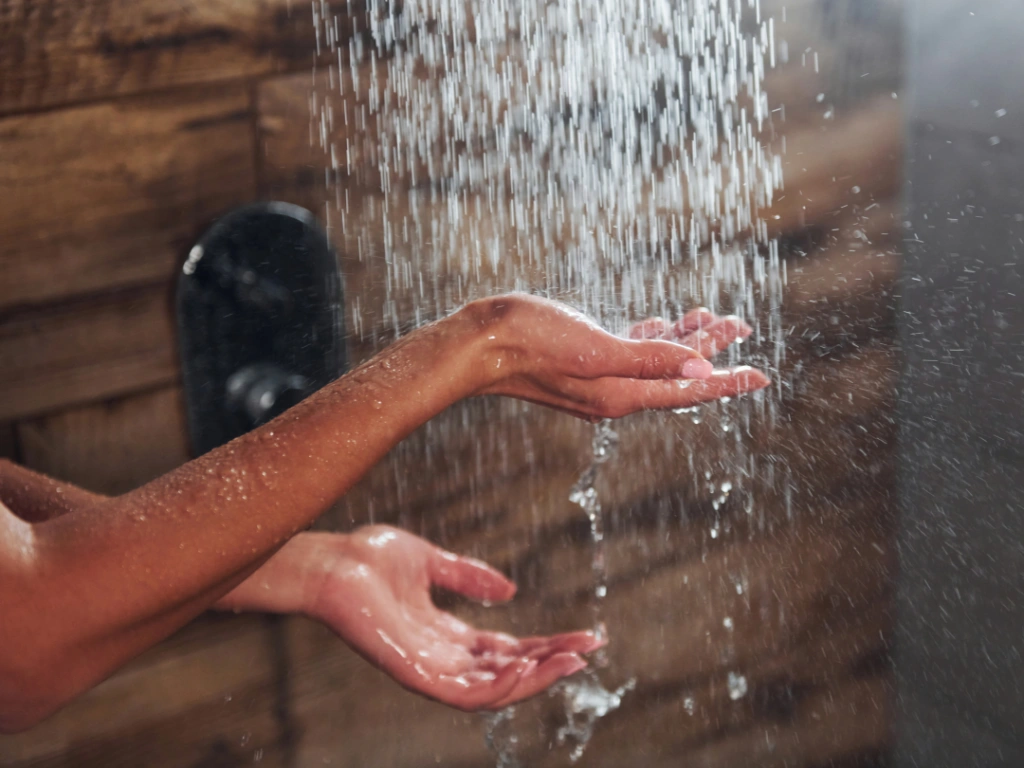 woman-catching-water-from-tankless-water-heater